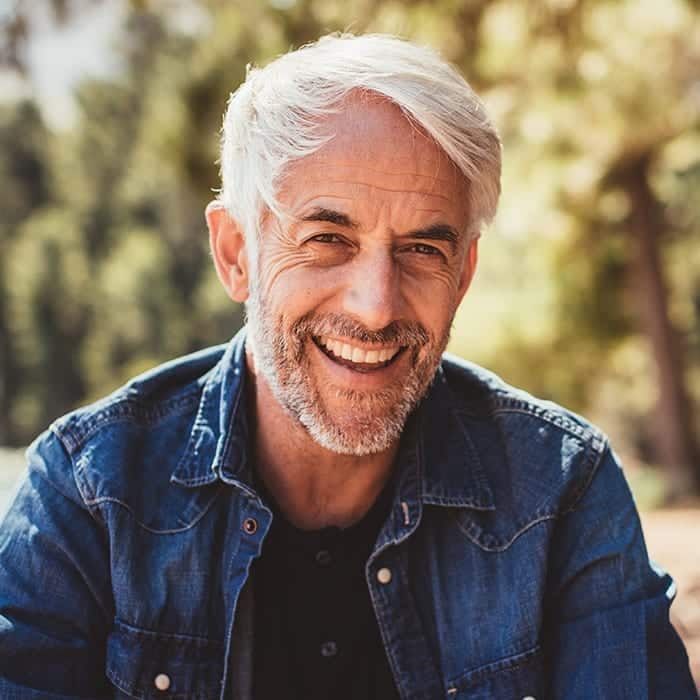 man smiling with beautiful new dental crowns from 21st Century Dentistry in Nashville